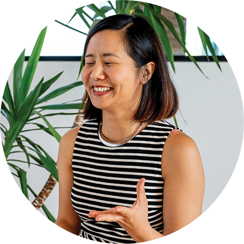 Female Asian Grantbook employee, smiling and laughing