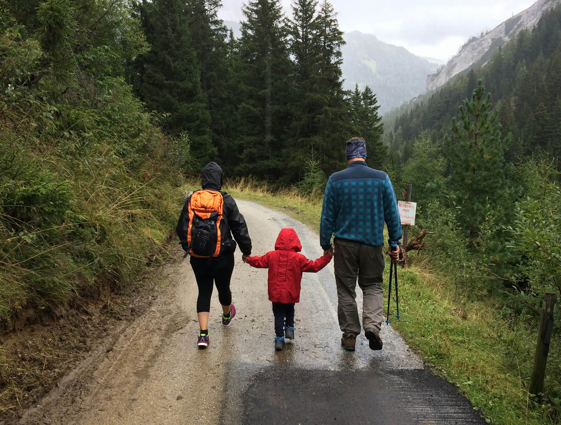 Photo of a family hiking in the rain